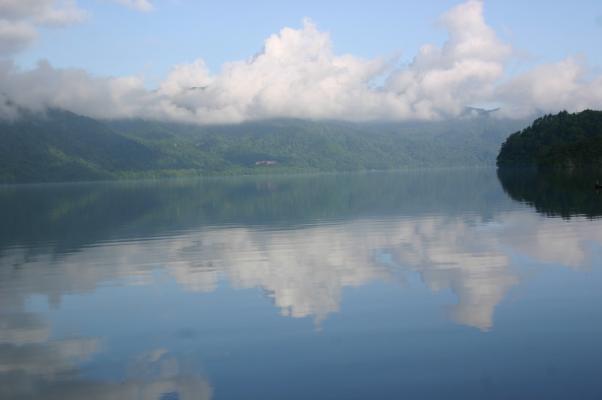 朝の静かな十和田湖、湖面に映る鏡面像
